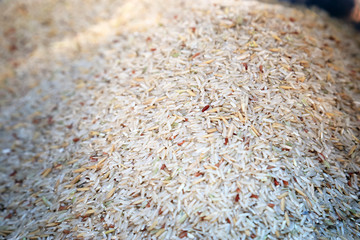 Pile of organic brown rice background.