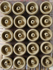 Closeup of fresh candlesticks, earthenware, pottery drying indoor. The classical and unique handmade product of Thailand.
