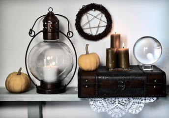 Pentagram, magic crystal ball, old lamp and pumpkins on shelf. Magic gothic ritual. Wicca,...