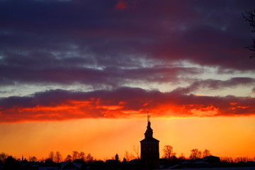 Fototapeta na wymiar Vivid pictures of the sunset in the winter with the Church in Russia