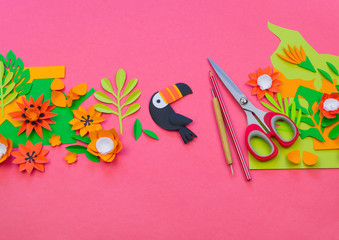 Creative setting. The process of cutting leaves and flowers from paper. Tropics exotic jungle.