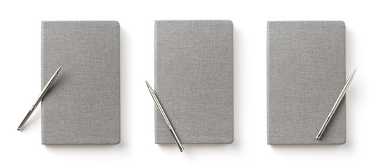 Business concept - Top view collection of  grey notebook front, back pen, and white open page isolated on background for mockup
