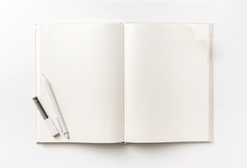 Business concept - Top view collection of  light yellow fabric notebook, pen, flip curl rolled page and white open page isolated on background for mockup