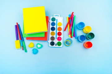 Stationery for study at school lies on blue. Back to school. Rainbow color