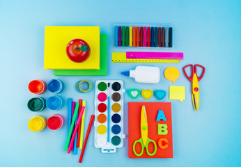 Stationery for study at school lies on blue. Back to school. Rainbow color