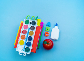 Stationery for study at school lies on blue. Back to school. Rainbow color