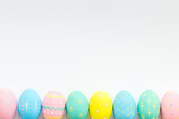 Fototapeta na wymiar Decorated Easter eggs on white background border space for text