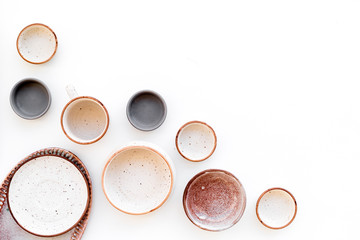 Ceramic tableware pattern. Empty plates and mugs on white background top view space for text
