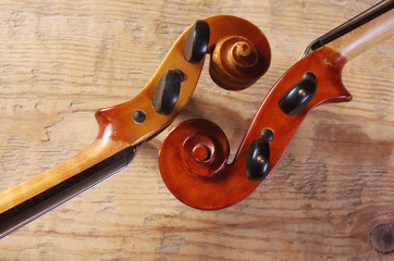 Two fingerboards of violins on a wooden table
