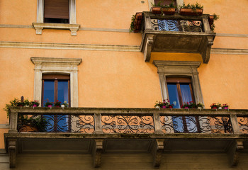 Beautiful Verona balconies with flowering geraniums. Oil painting effect finish.