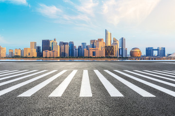 Zebra crossing road and modern city skyline with buildings in Hangzhou