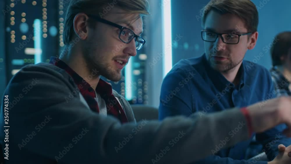 Poster Two Professional IT Programers Discussing Technical Data Show on Desktop Computer Display. Working Data Center Technical Department with Server Racks in the Background