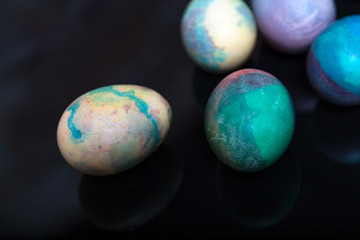 Group of easter painted eggs on black background