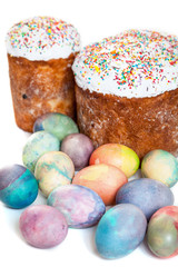 Fototapeta na wymiar Two Easter cakes and colorful eggs on white background