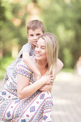 Fototapeta premium Mother and son outdoors in park