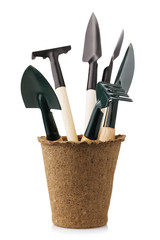 Garden tools in peat pot isolated on white background