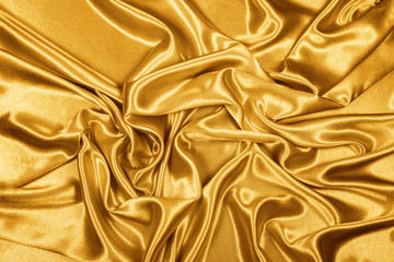 Gold luxury satin fabric texture for background and art design