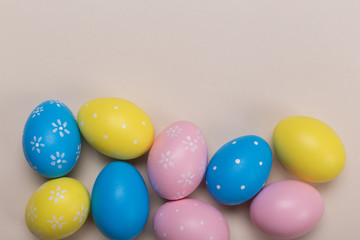 Colorfull easter eggs in nest on pastel color background with space. Concept
