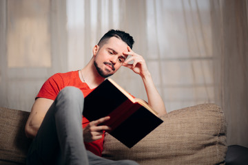 Man Relaxing at Home Reading a Book