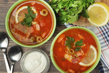 Two bowls with traditional Russian soup solyanka