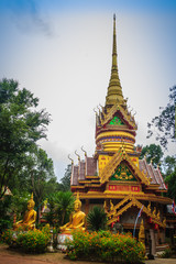 Fototapeta premium Beautiful golden pagoda with decorative Thai style fine art at public Buddhist Wat Phu Phlan Sung temple, Nachaluay, Ubon Ratchathani, Thailand.