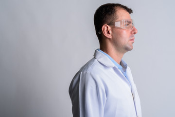 Closeup profile view of man doctor with protective glasses