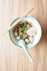 Dry noodle with pork meatball and Tofu with pork on the wood table