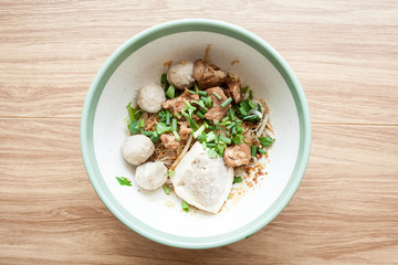 Dry noodle with pork meatball and Tofu with pork on the wood table