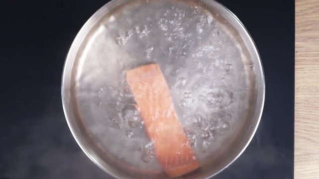 Cooking fish,  Boiling salmon in hot water