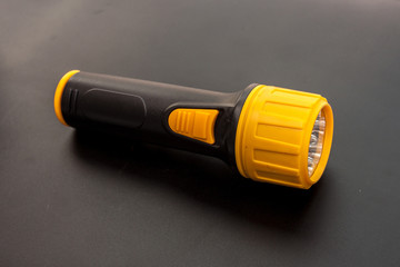 LED flashlight yellow color and black handle the tool in the emergency time