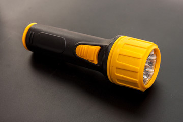 LED flashlight yellow color and black handle the tool in the emergency time