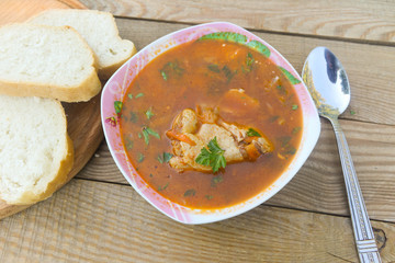Ukrainian and Russian beetroot soup - borscht with chicken meat on wooden table. Top view