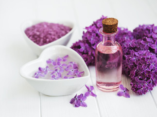 Fototapeta na wymiar Essential oil and sea salt with lilac flowers