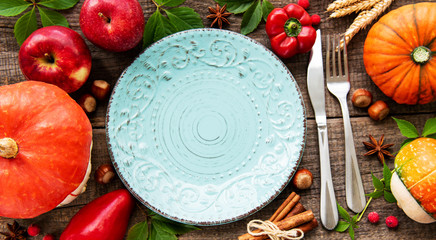 Empty plate and pumpkins