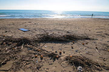 Fototapeta na wymiar Pollution on the beach of tropical sea. Plastic garbage, foam, wood and dirty waste