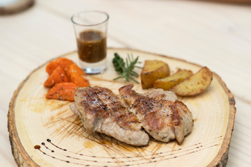 Steak on a wooden plate
