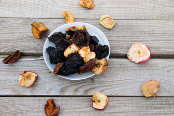 Dried fruits in a plate on wooden table