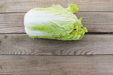 Whole chinese cabbage on rustic wooden table