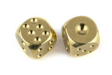 Two golden dice closeup isolated on white background. Six and one with a shadow.