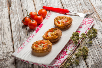 mini pizzas with tomatoes mozzarella and oregano