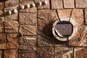 Old decor stone wall with hole. Part of old castle. Stone background.