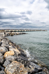 Dramatic landscape on a storm sea in Iskenderun, Turkey with stone pier