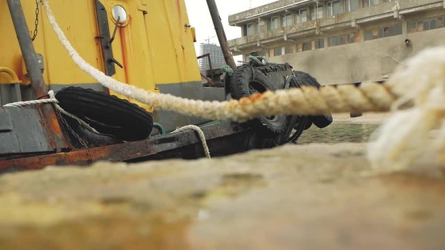 old yellow longboat on a pier at the shore