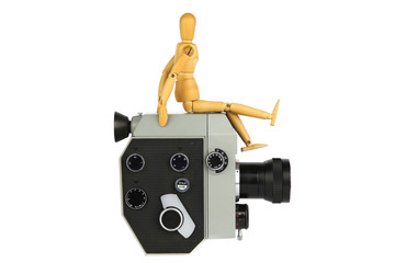 Wooden model of man sitting on old movie camera