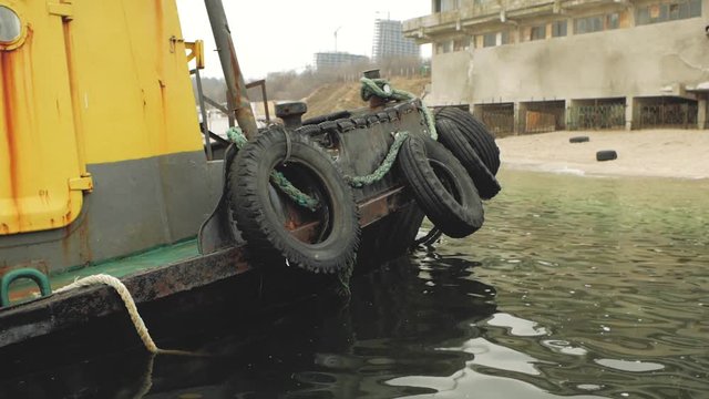 old yellow longboat on a pier at the shore