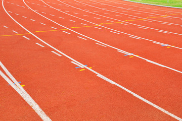 Fototapeta premium Athletics Track Run / Red running track in stadium with green field