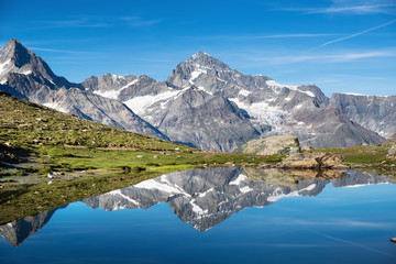 Fototapeta na wymiar Mountain lake in Switzerland. High mountains region at the day time. Natural landscape in Swiss mountains. Switzerland landscape - image