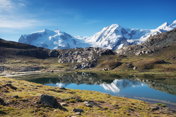Fototapeta na wymiar Mountain lake in Switzerland. High mountains region at the day time. Natural landscape in Swiss mountains. Switzerland landscape - image
