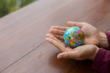 Children hand holding Earth globe model ball,Concept: Protecting the environment to save the world,The dream of sustainability for the new world,symbol responsibility safety  for happy