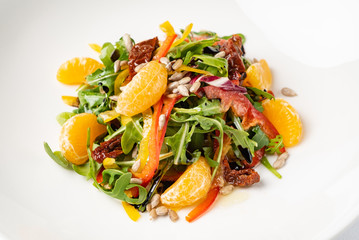 vegan salad with arugula and mandarines